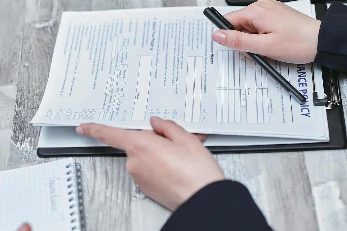 South Florida driver reviewing an auto insurance policy document and PIP coverage page