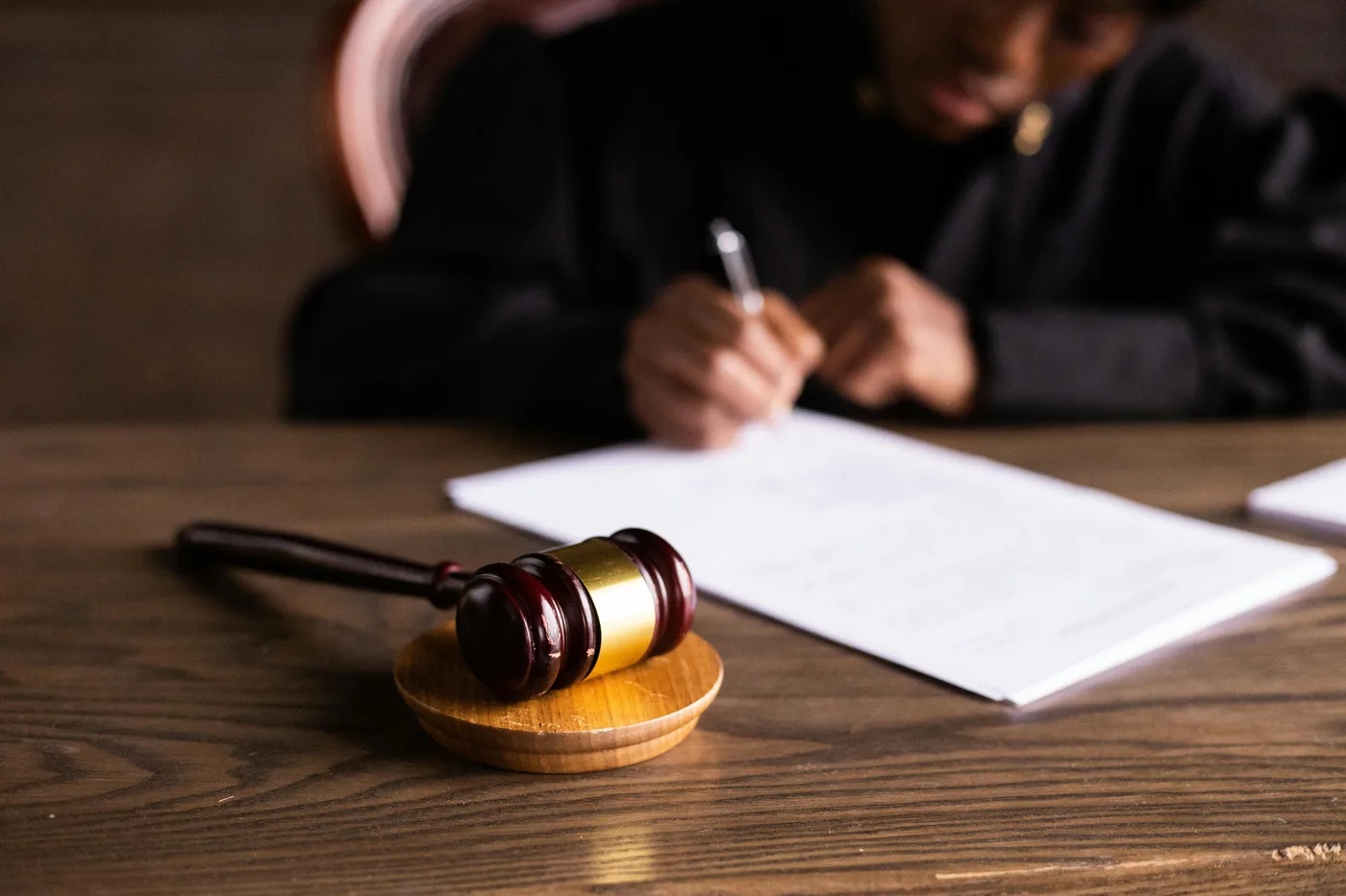 Gavel beside paperwork being signed, the moment a complaint is filed and the statute of limitations is preserved
